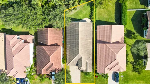 an aerial view of a house with a yard and fountain