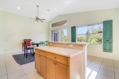 a kitchen with a stove a refrigerator a sink and chairs