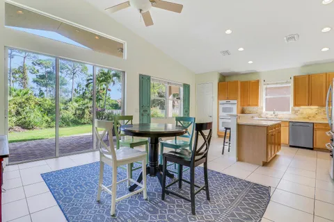 a view of a dining room and kitchen with a table & chairs