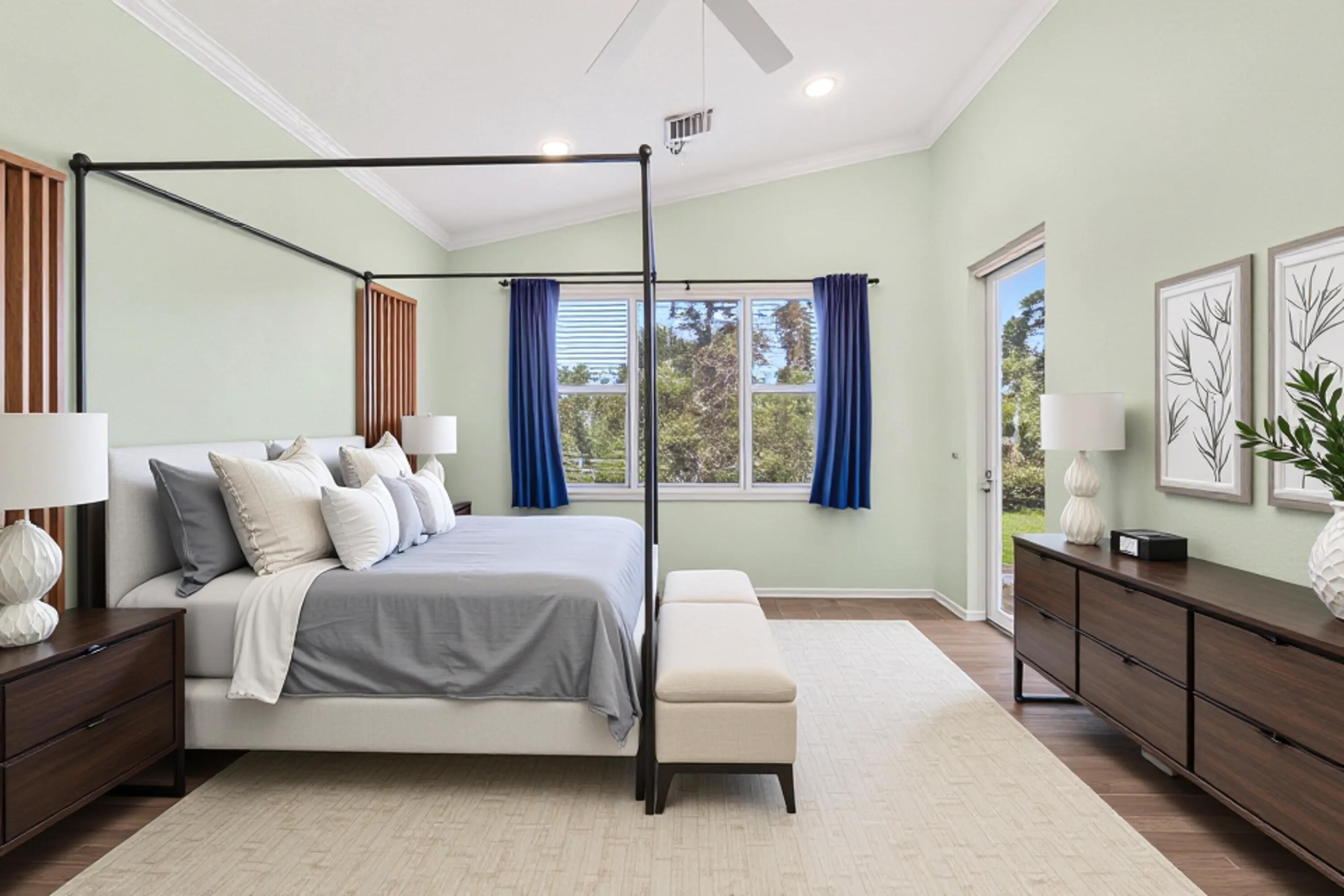 5017 Southeast Graham Drive Stuart, FL 34997 - Photo 19 of 38 a bedroom with a large bed and a chandelier