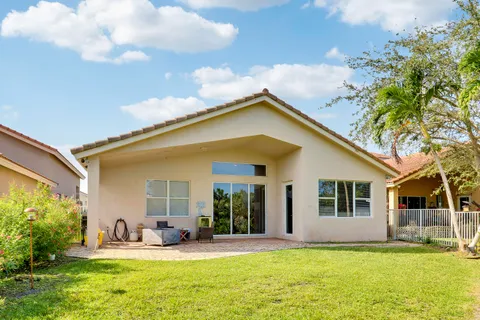 a view of a house with a yard patio and fire pit