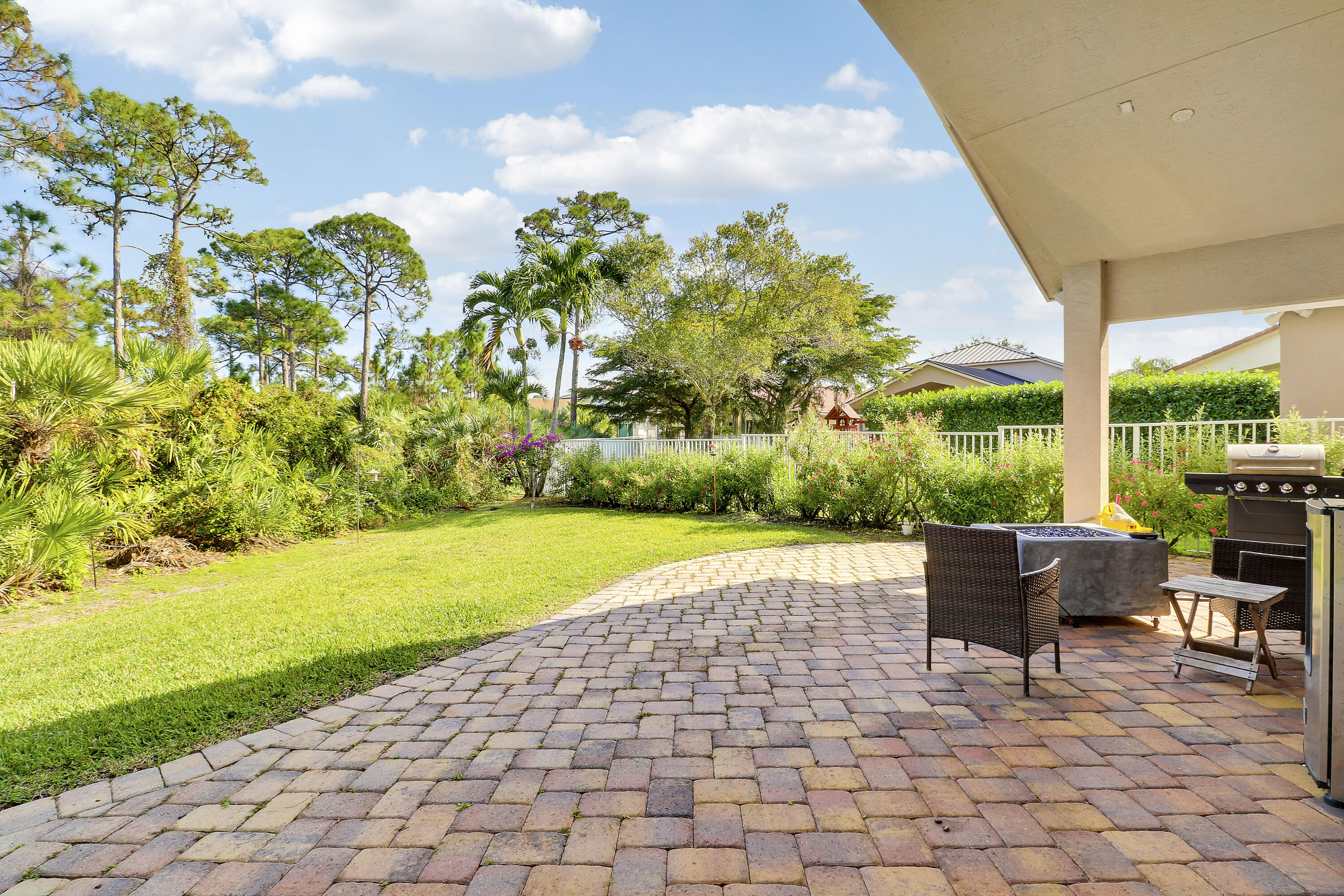 5017 Southeast Graham Drive Stuart, FL 34997 - Photo 30 of 38 a view of a patio with a table and chairs under an umbrella