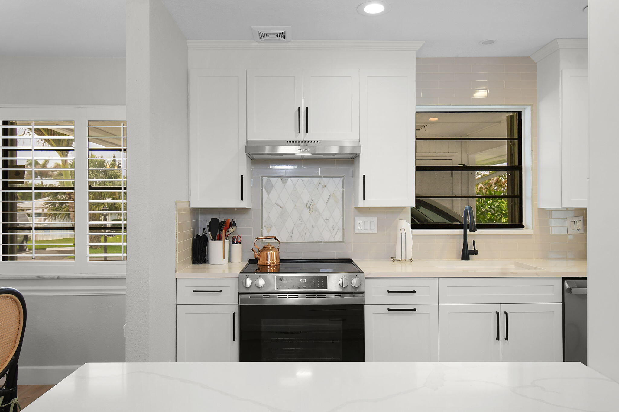5251 Southeast Sea Island Way Stuart, FL 34997 - Photo 10 of 68 a kitchen with stainless steel appliances granite countertop a stove and a sink