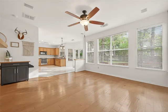 a view of a livingroom with wooden floor and a window