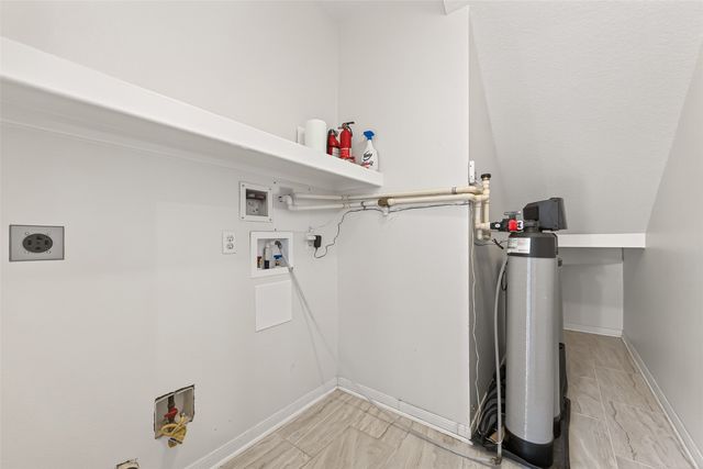a view of storage and utility room with refrigerator