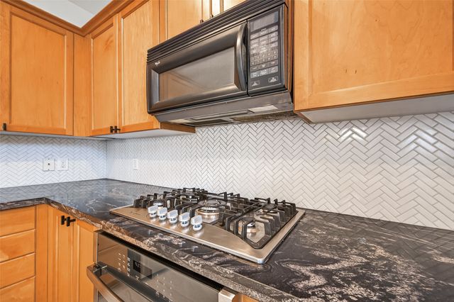 a stove top oven sitting inside of a kitchen