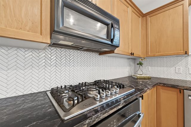 a kitchen with a stove and a microwave