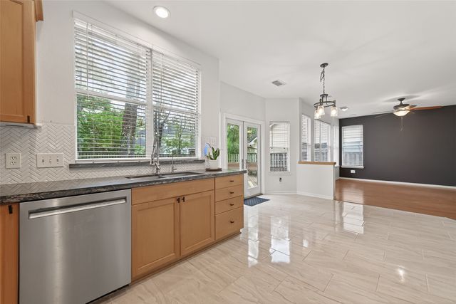 a large kitchen with cabinets and wooden floor