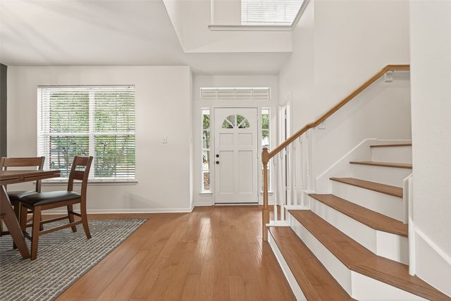 a view of a livingroom with wooden floor and a window