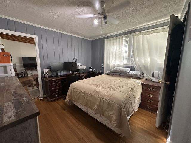 a bedroom with a bed and wooden floor