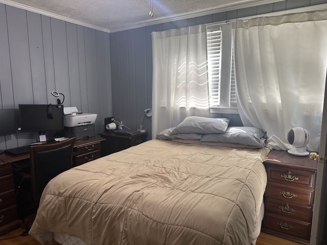 a bedroom with a bed and window