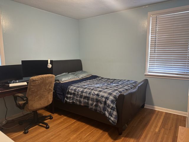 a bedroom with a bed and a desk