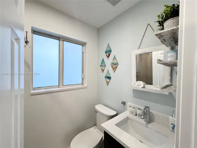 a kitchen with a refrigerator and a sink