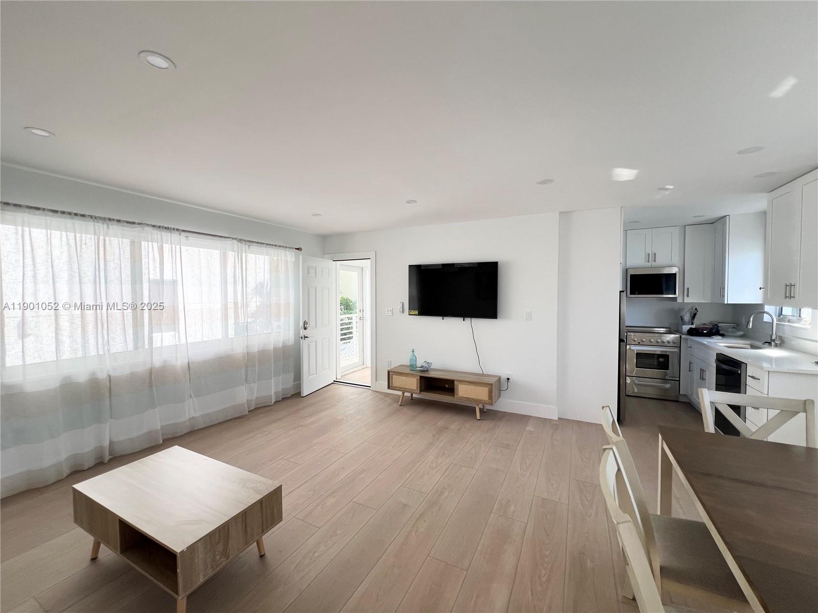 312 Elm Street Hollywood, FL 33019 - Photo 20 of 52 a living room with furniture and a flat screen tv