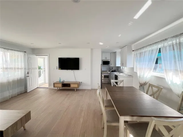 a bathroom with a sink mirror and a window