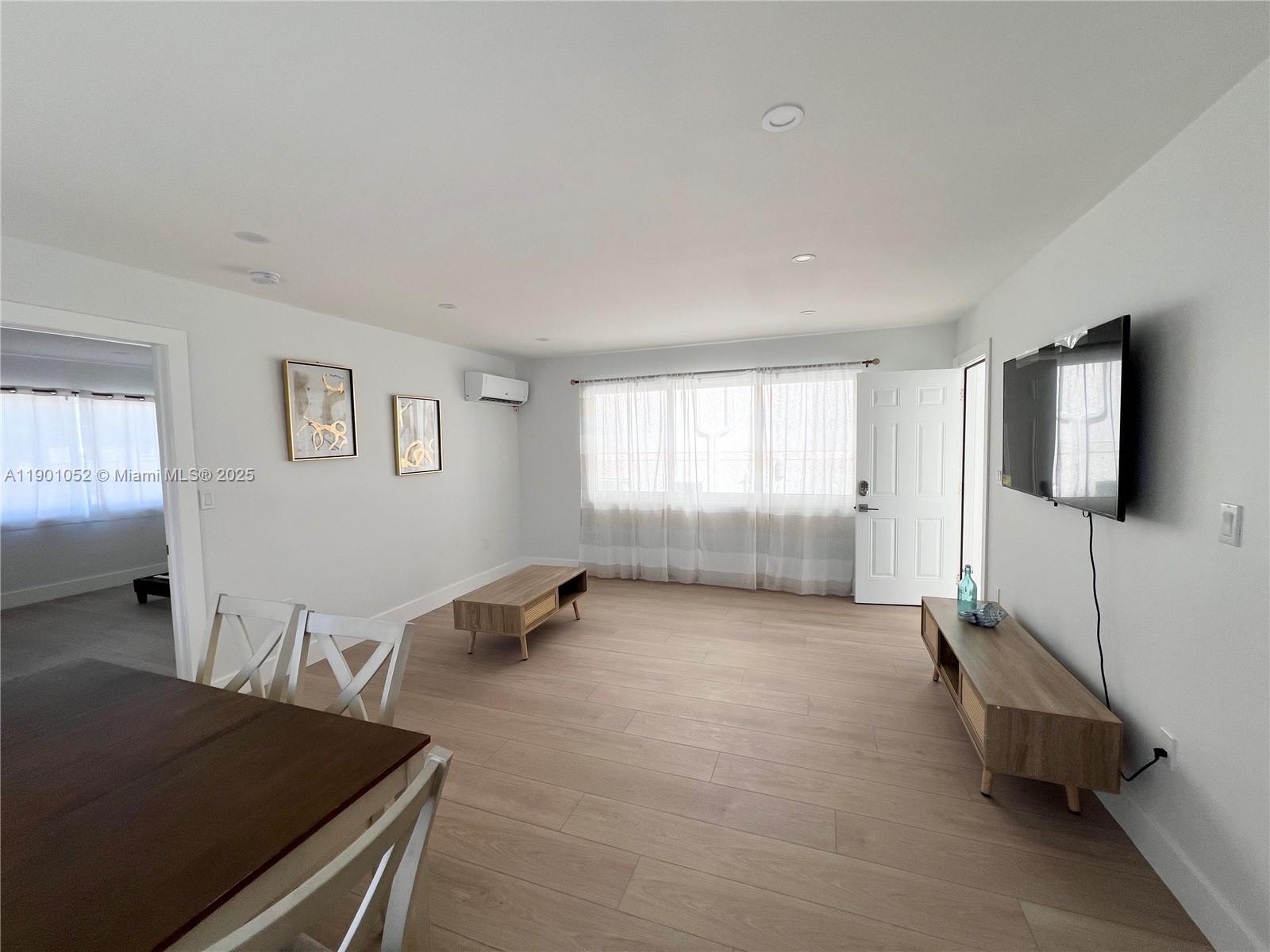 312 Elm Street Hollywood, FL 33019 - Photo 27 of 52 a living room with furniture and a flat screen tv