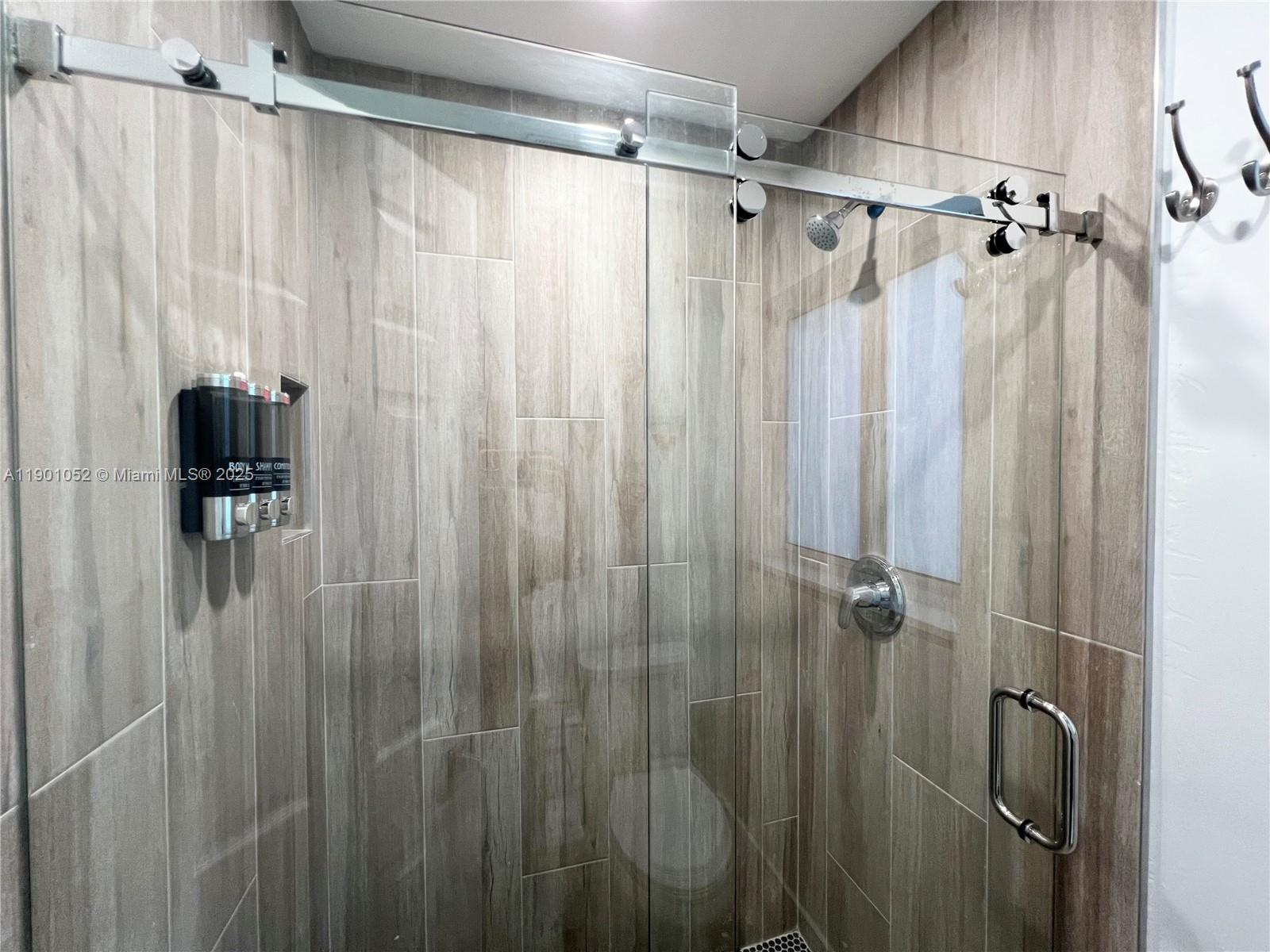 312 Elm Street Hollywood, FL 33019 - Photo 36 of 52 a bathroom with a shower and a tub