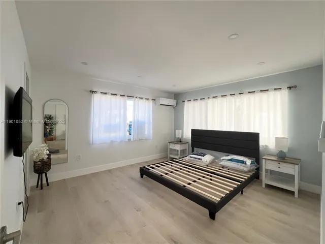 a kitchen with a refrigerator and a stove top oven