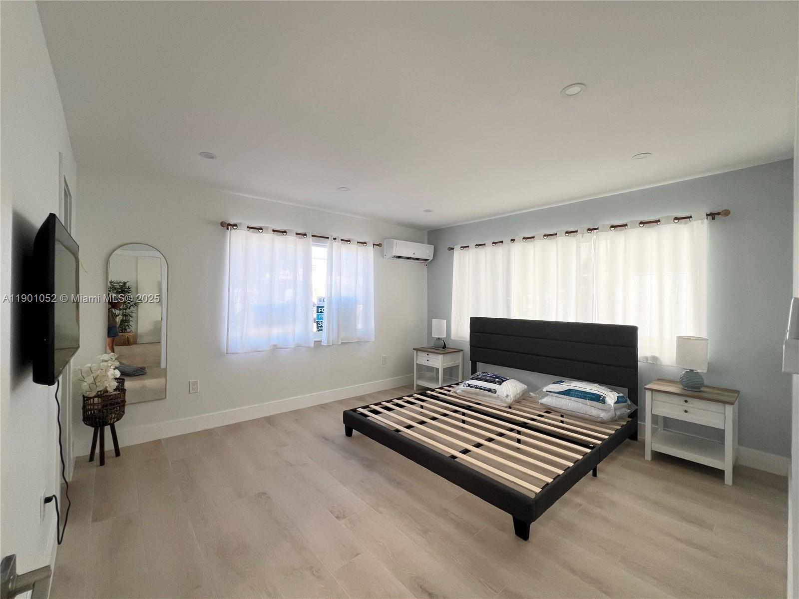 312 Elm Street Hollywood, FL 33019 - Photo 46 of 52 a bedroom with a bed and wooden floor