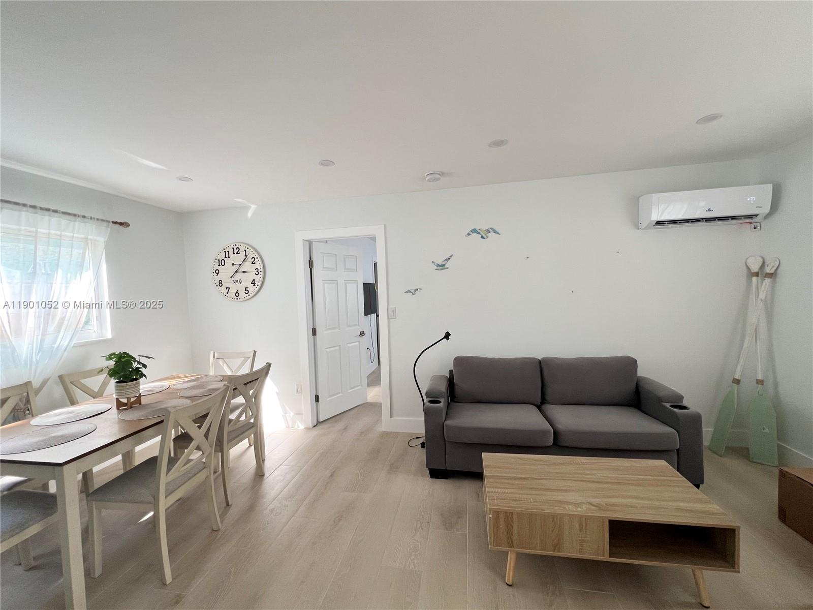 312 Elm Street Hollywood, FL 33019 - Photo 49 of 52 a living room with furniture a rug and a window