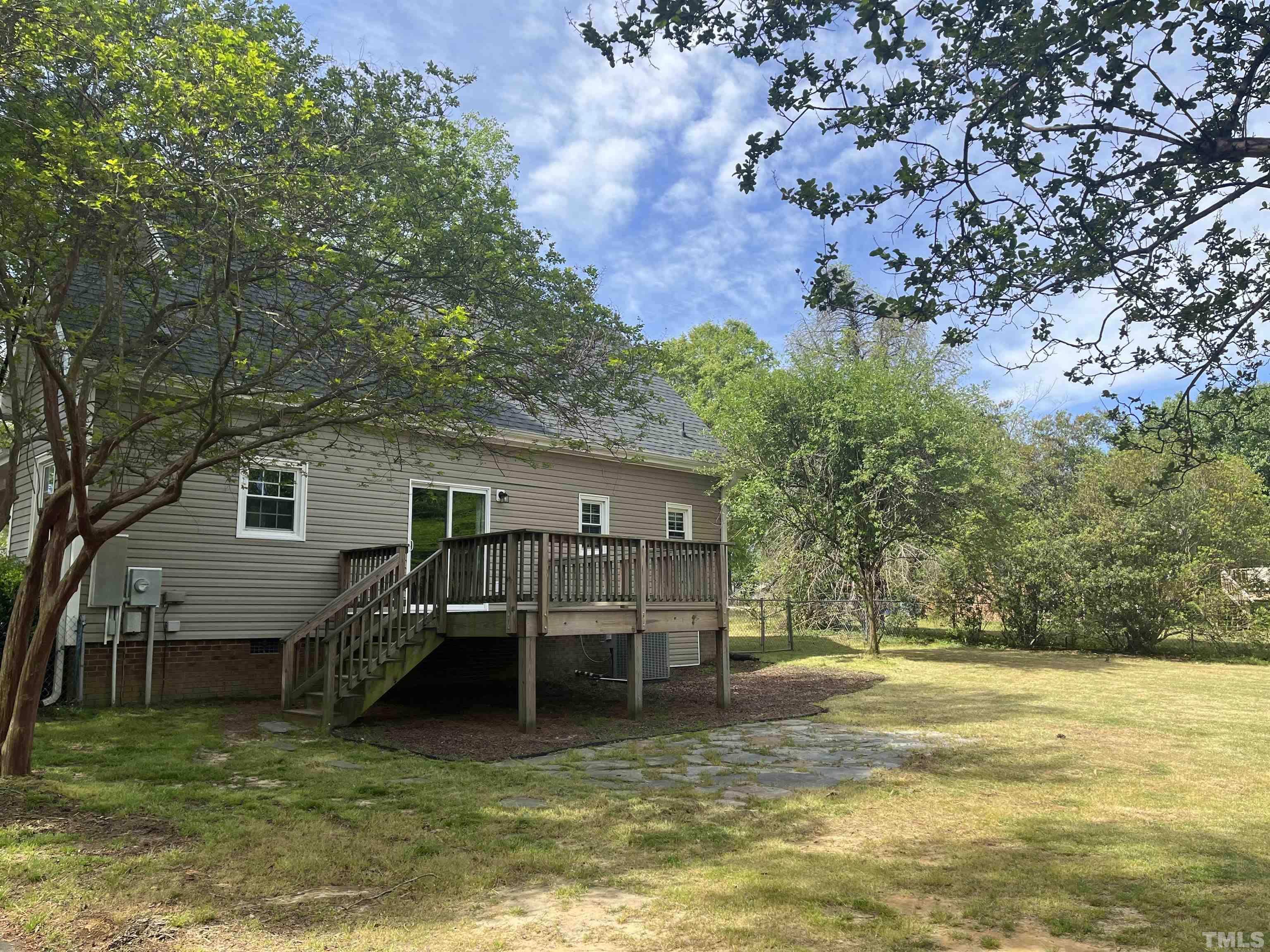 3590 Sanders Road Willow Spring, NC 27592 - Photo 4 of 6 a view of a house with a yard balcony and tree