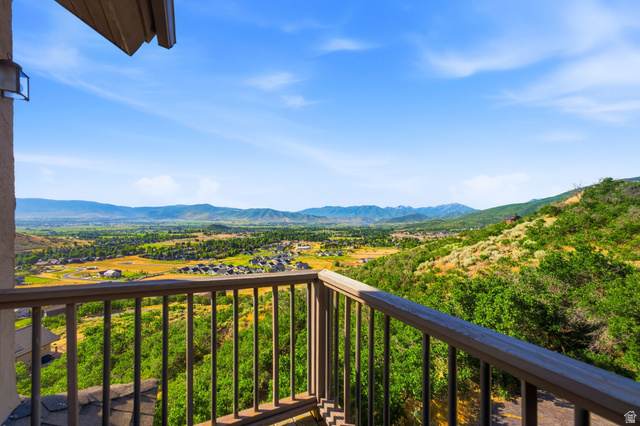 335 Bern Way Midway, UT 84049 - Photo 32 of 88 Balcony with wood railing overlooking a valley with distant mountains and residential areas