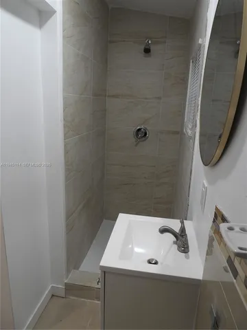 a kitchen with a refrigerator and a stove top oven