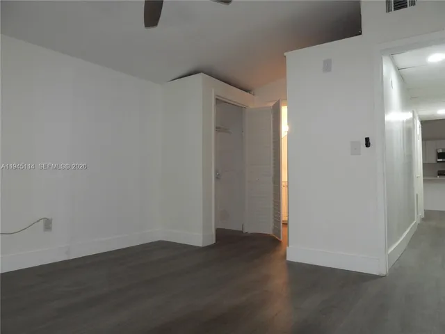 a view of a kitchen with a sink microwave and cabinets