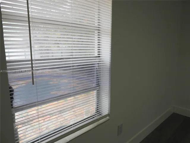 a large kitchen with a refrigerator and a stove top oven