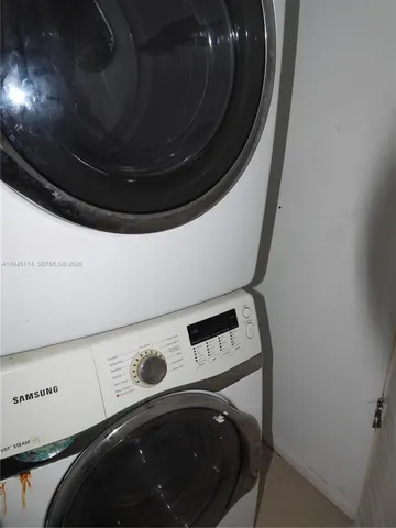 an empty room with wooden floor and a ceiling fan