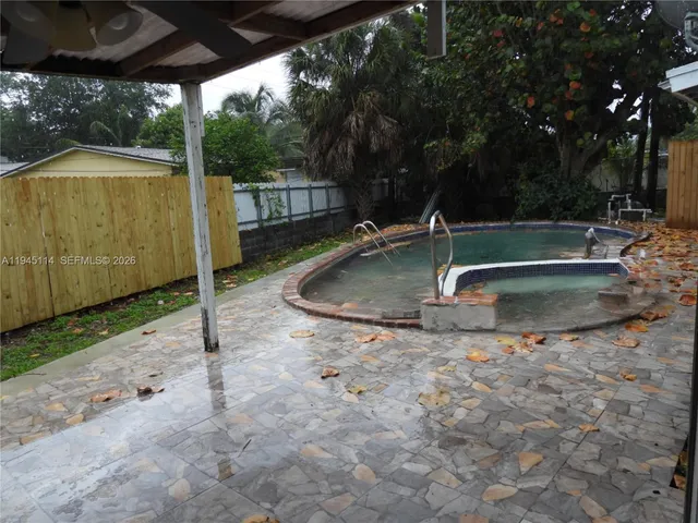 a room with a sink a washer and dryer