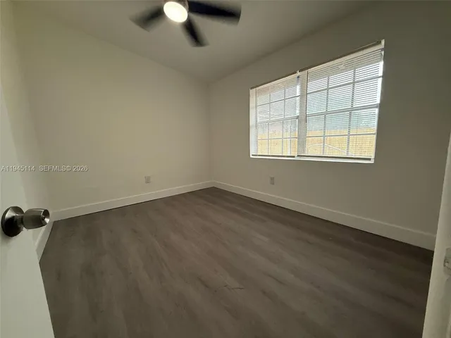a bathroom with a toilet and a mirror