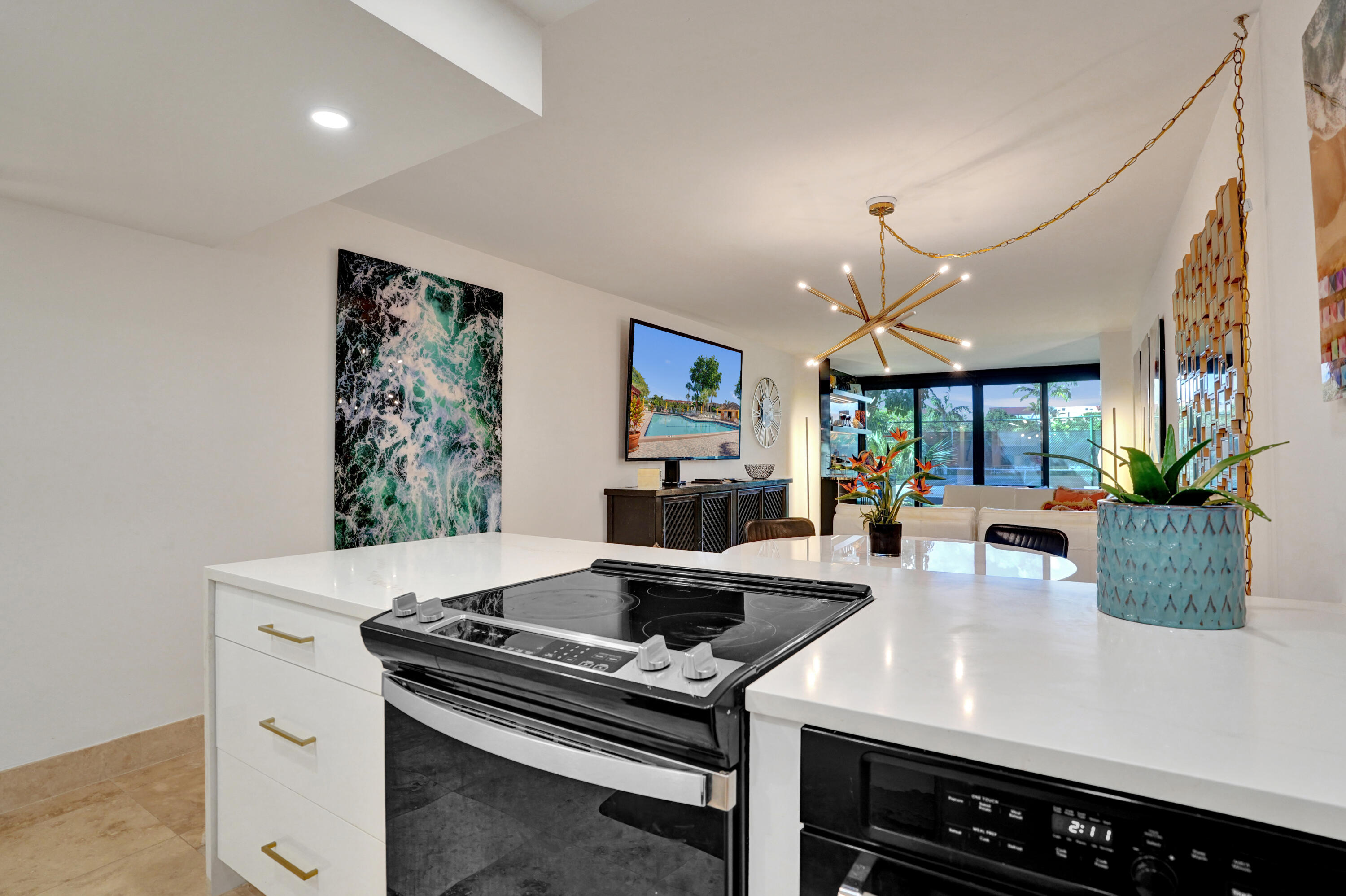 755 Dotterel Road, Unit 1112 Delray Beach, FL 33444 - Photo 17 of 59 a kitchen with a stove and a chandelier
