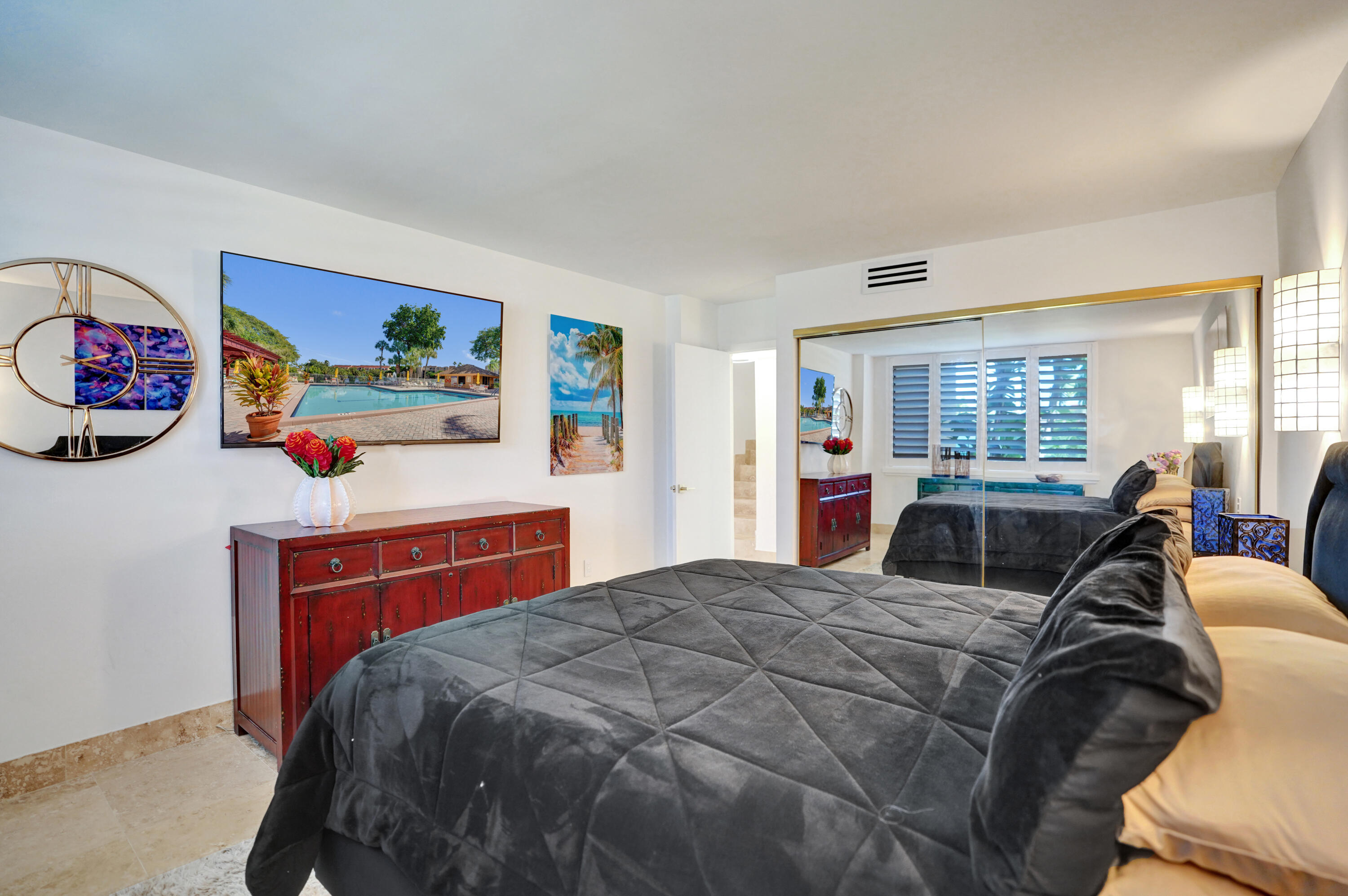 755 Dotterel Road, Unit 1112 Delray Beach, FL 33444 - Photo 21 of 59 a bedroom with a bed and a dresser in it