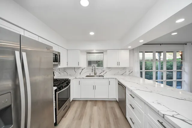 a kitchen with a sink stove and refrigerator