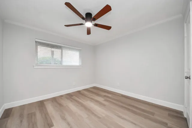 a view of empty room with ceiling fan