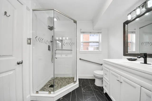 a bathroom with a shower and a glass door