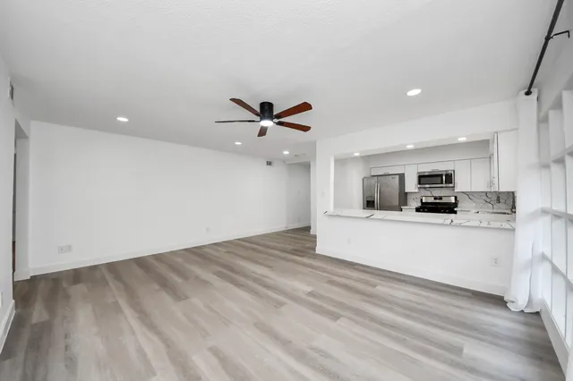 a view of kitchen with sink and wooden floor
