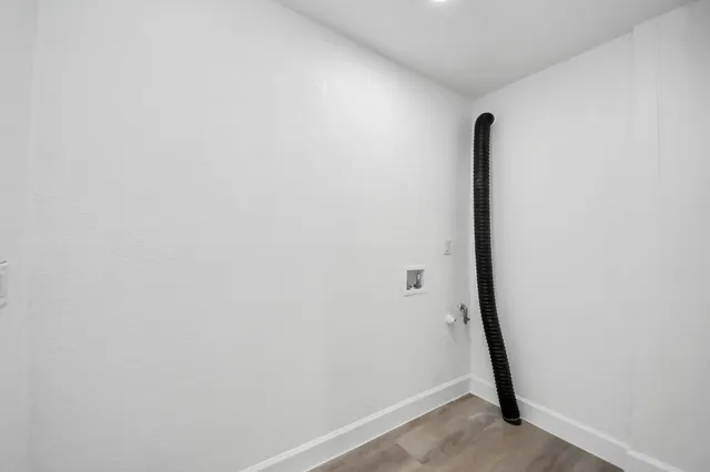 an empty room with a window and ceiling fan