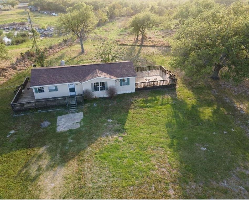 a aerial view of residential houses with yard