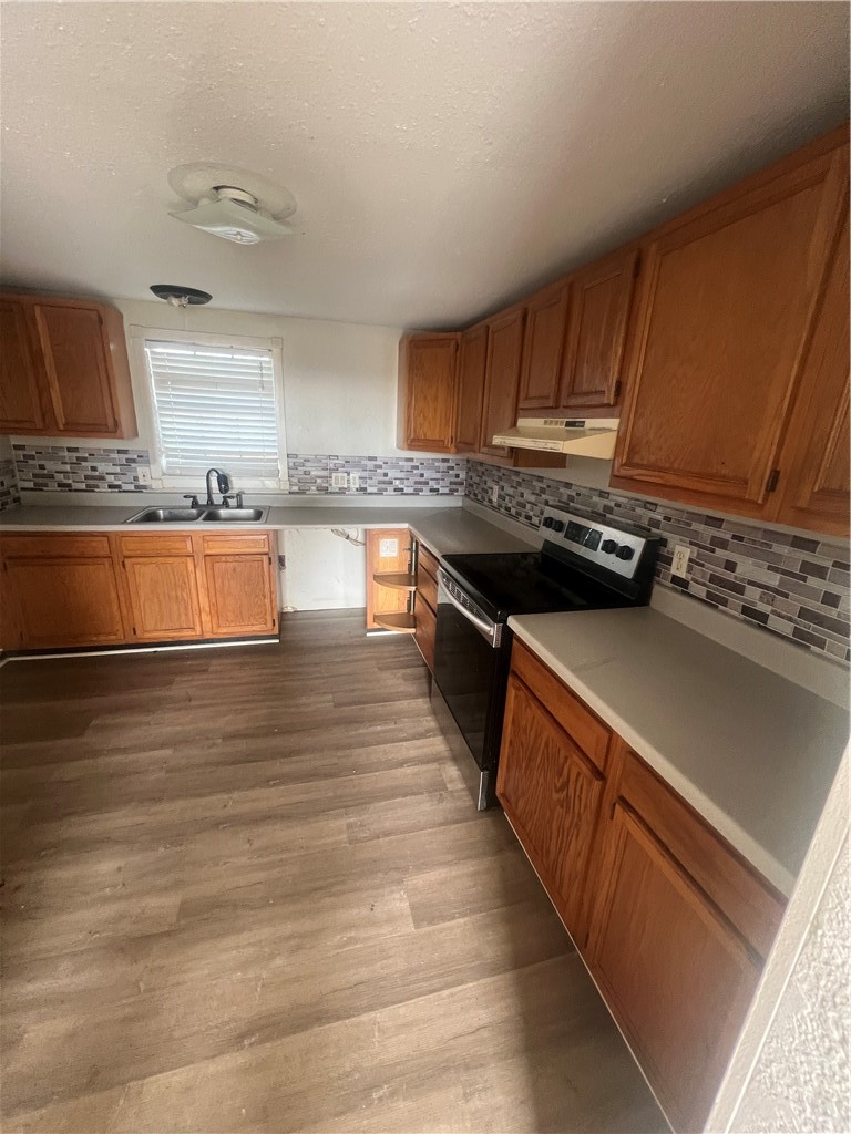 615 Monkey Road Rockport, TX 78382 - Photo 5 of 15 a kitchen with stainless steel appliances granite countertop a stove a sink and a refrigerator