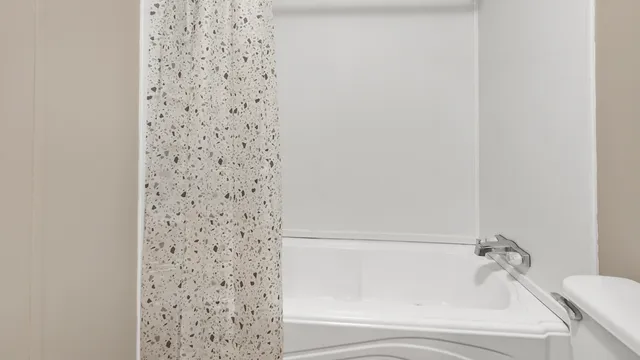 a bathroom with a bathtub and shower