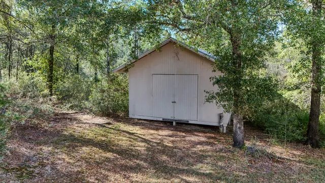 a view of barn house with a small yard