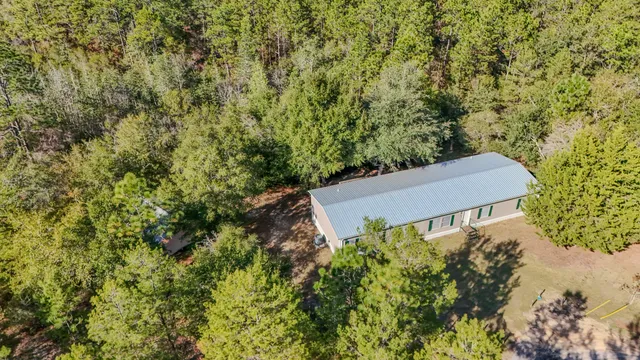 an aerial view of a house with yard and outdoor space