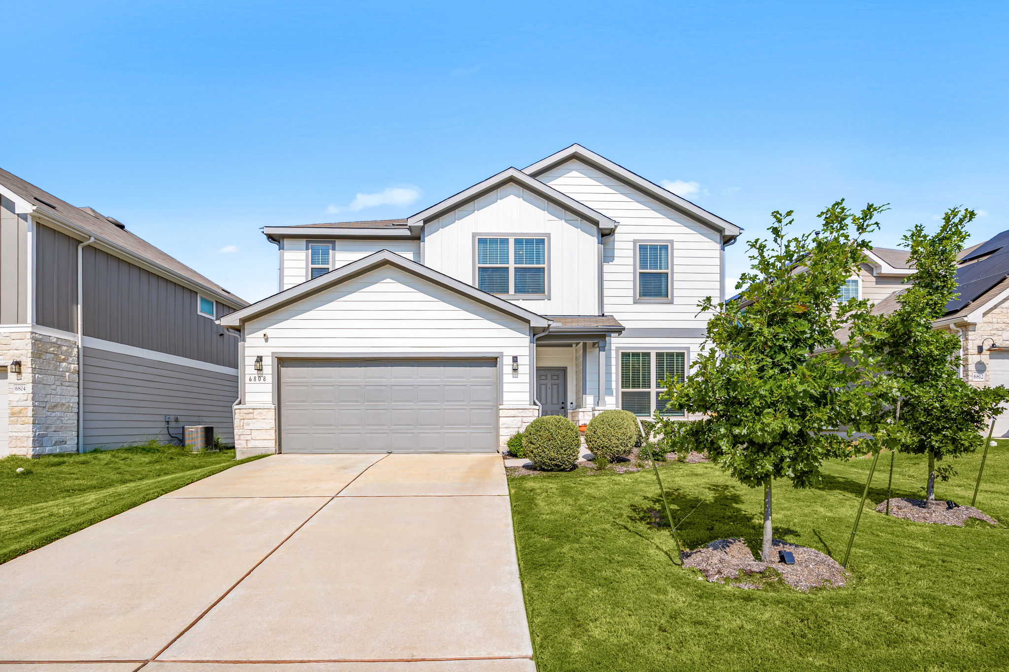 a front view of a house with a yard and garage