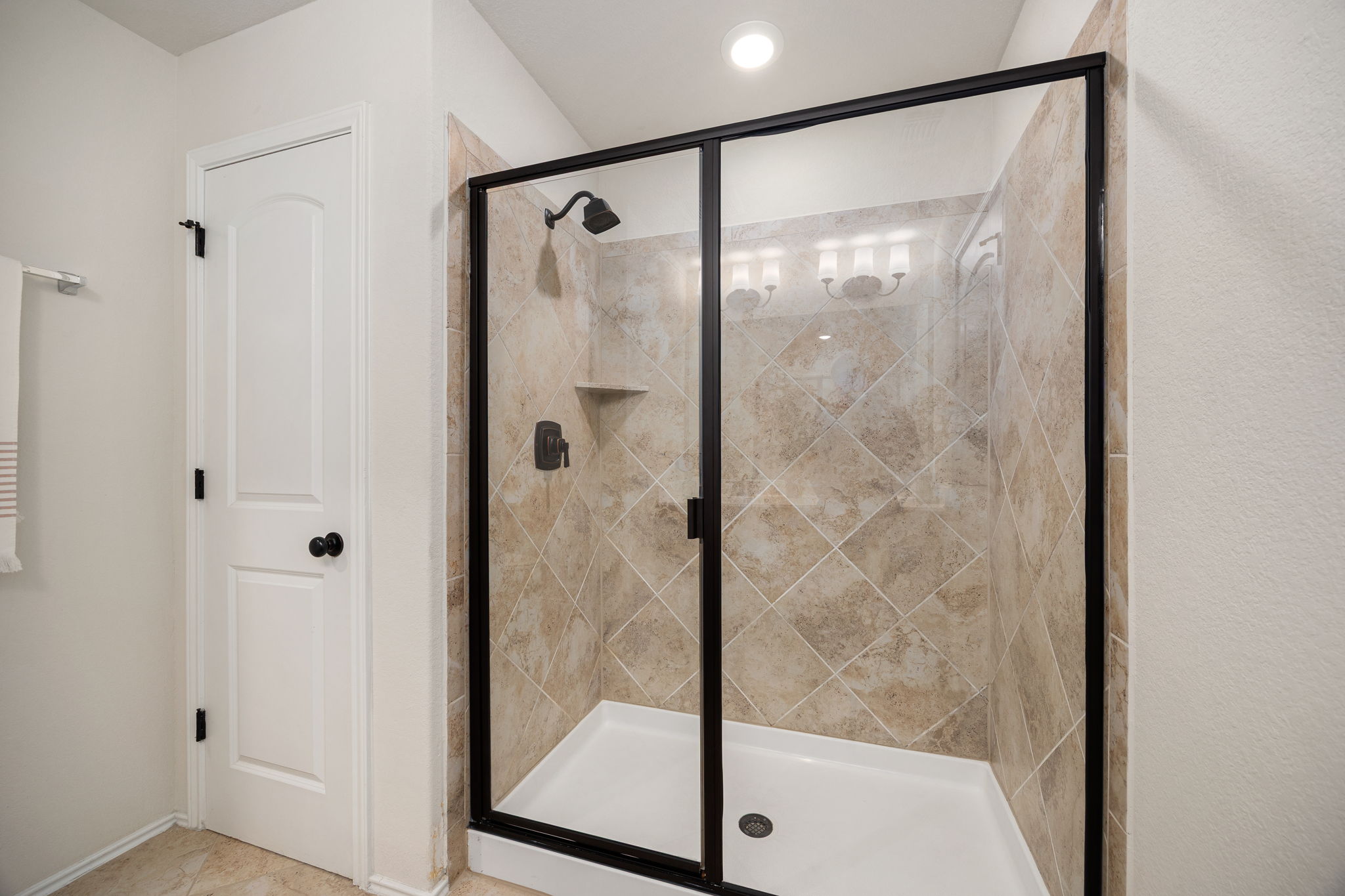 6808 Ellsworth Walk Austin, TX 78724 - Photo 21 of 40 a bathroom with a glass shower door