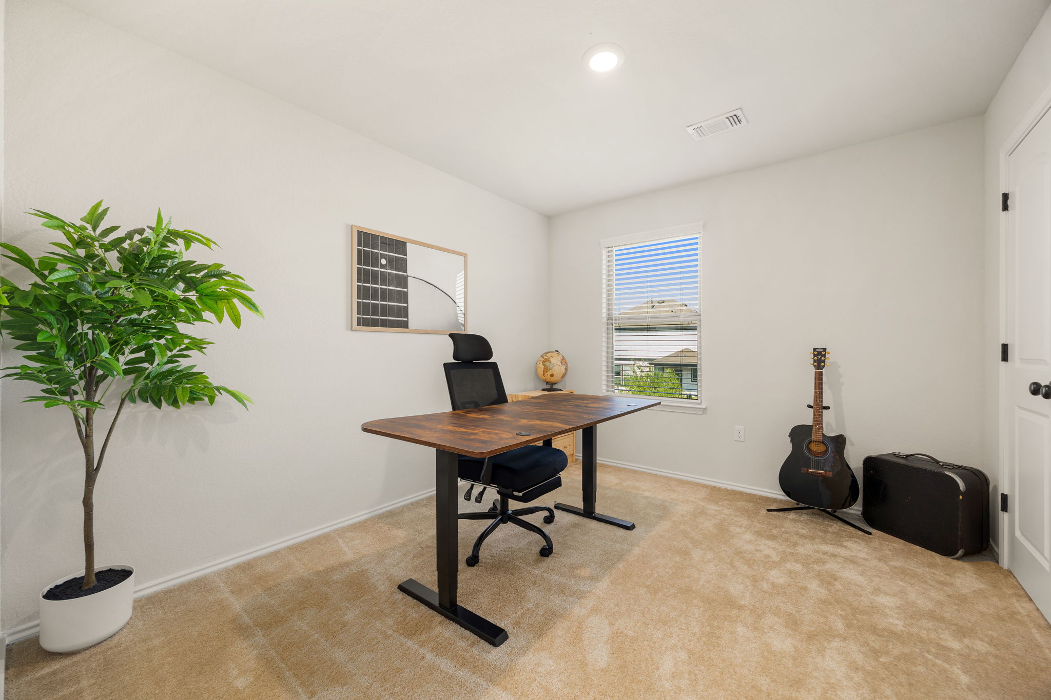 6808 Ellsworth Walk Austin, TX 78724 - Photo 25 of 40 a workspace with furniture and a potted plant