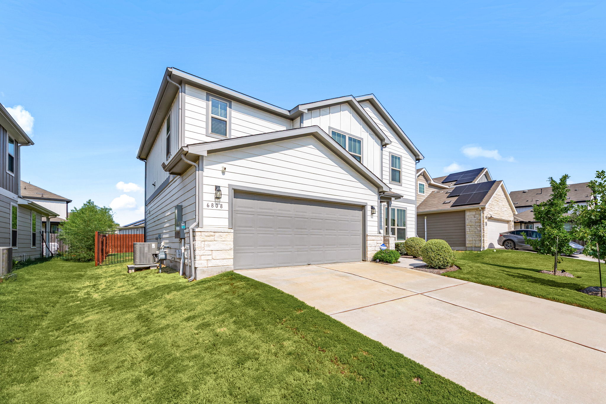 6808 Ellsworth Walk Austin, TX 78724 - Photo 3 of 40 a front view of a house with a yard and garage