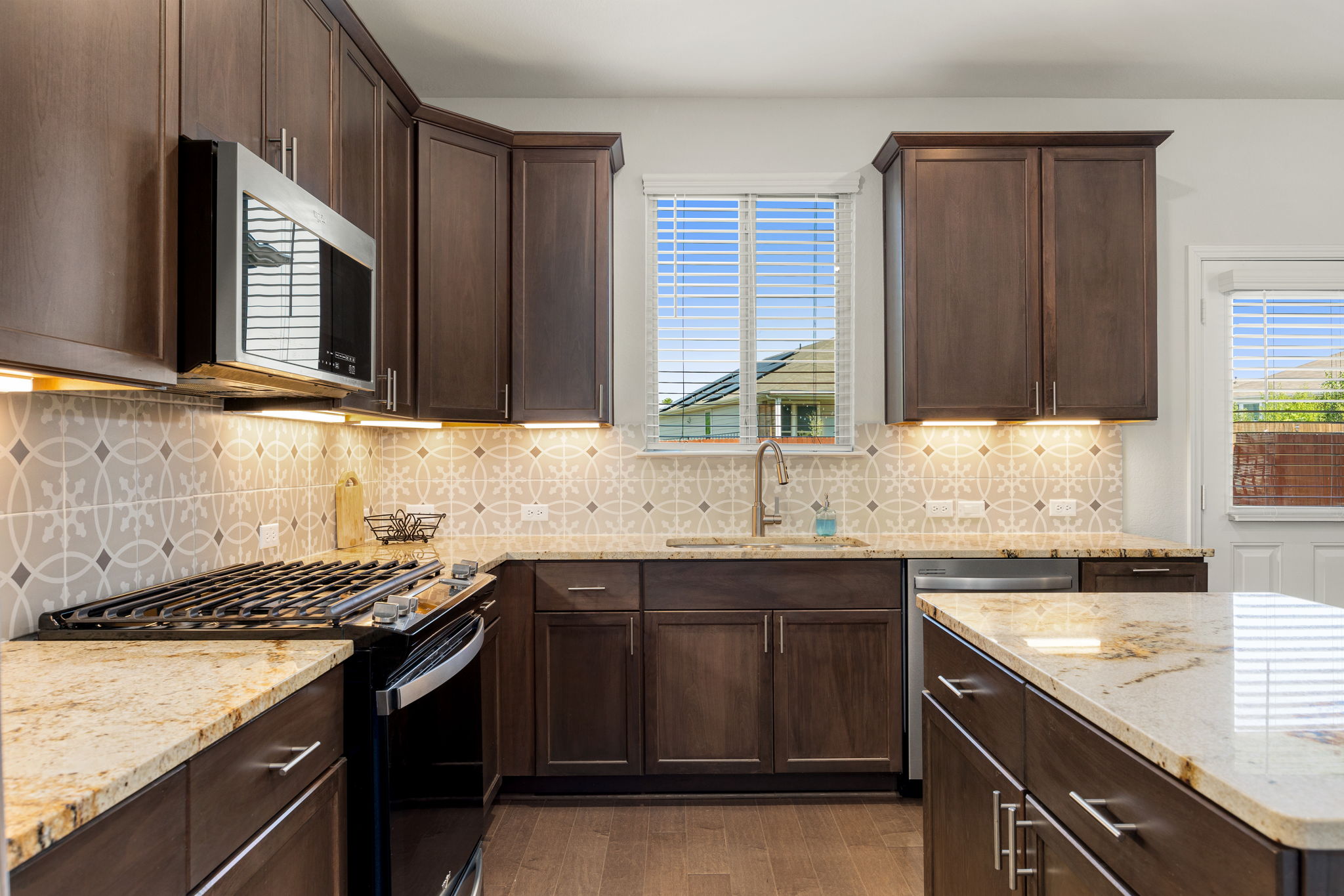 6808 Ellsworth Walk Austin, TX 78724 - Photo 8 of 40 a kitchen with a sink stove and cabinets