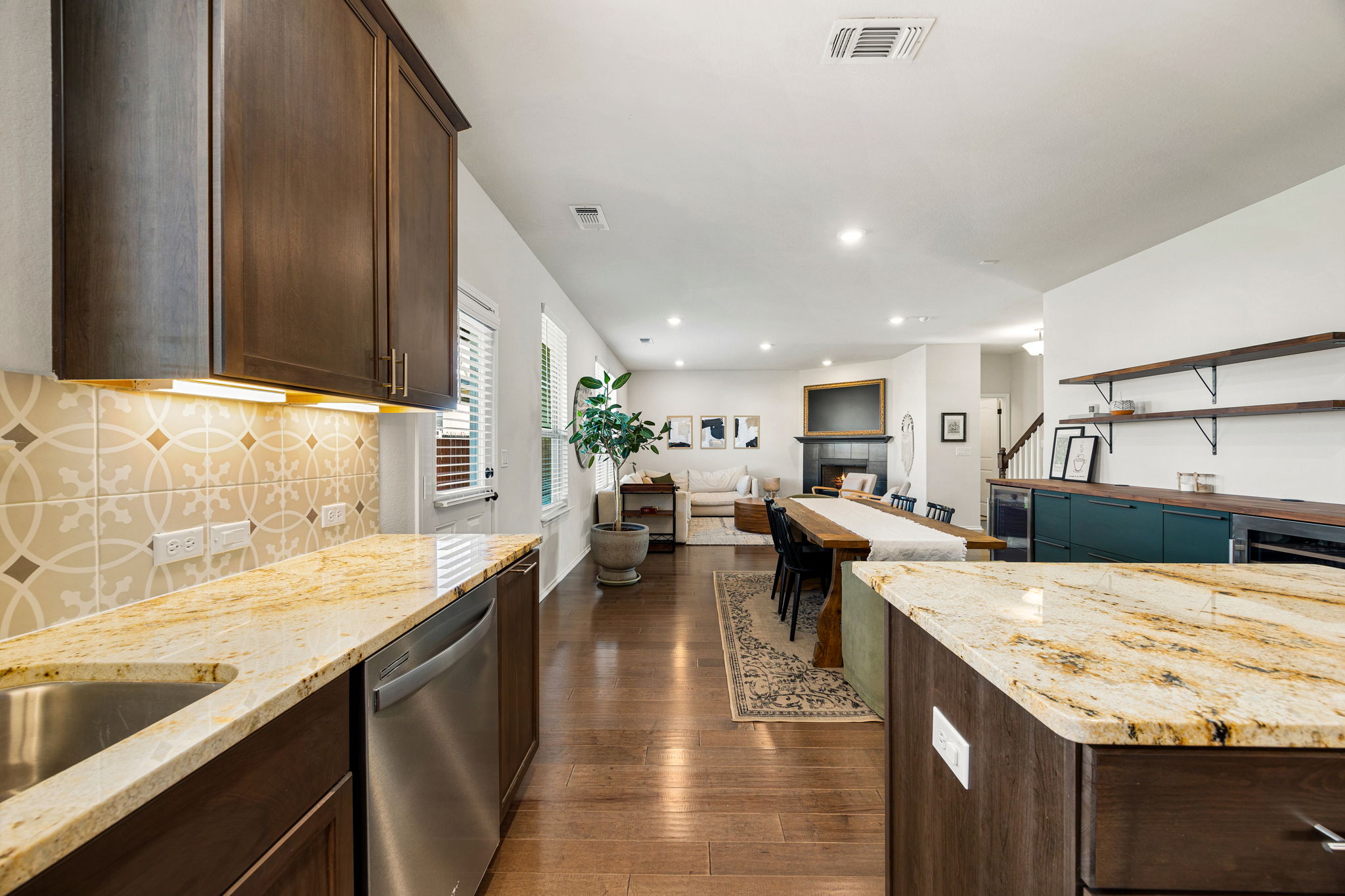 6808 Ellsworth Walk Austin, TX 78724 - Photo 10 of 40 a view of a kitchen with kitchen island stainless steel appliances a sink and counter top space